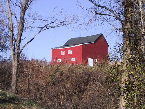 Photograph of a red house in the country