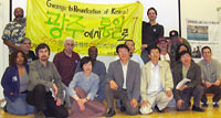 Detroit meeting for the Guangju, Korean 25th anniversary tour during 2005. PANW editor Abayomi Azikiwe holding banner on left. (Photo by Workers World Newspaper) by Pan-African News Wire Photo File