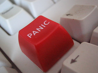 An image of a computer keyboard with a red key reading "PANIC"