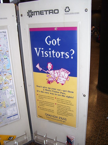 King County Metro Bus promotional poster at an information rack at the Seattle-Tacoma Airport