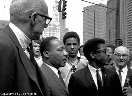 Dr. Martin Luther King, Jr. with Dr. Benjamin Spock and Bernard Lee at Chicago's anti-war march in March of 1967. by Pan-African News Wire File Photos