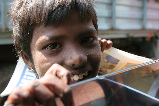 Child sells newspapers in India