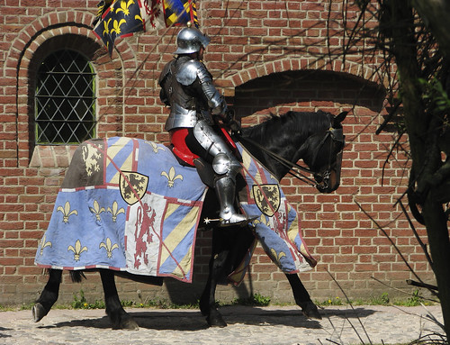 knight riding through the medieval town