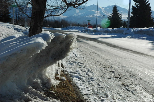 Breakup, melting ice and snow berm, Chugach Mountain Range, Lake Otis, Anchorage, Alaska, USA by Wonderlane