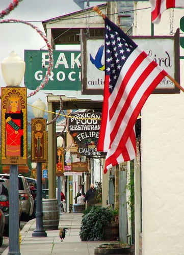 sidewalk, signs, flag, and rooster, San Juan Bautista, December 23, 2005