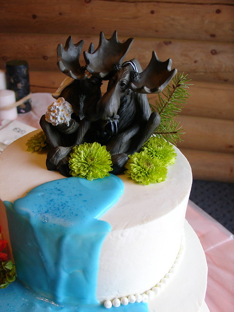 Westernthemed wedding cake Moose contemplate their love in an alpine 