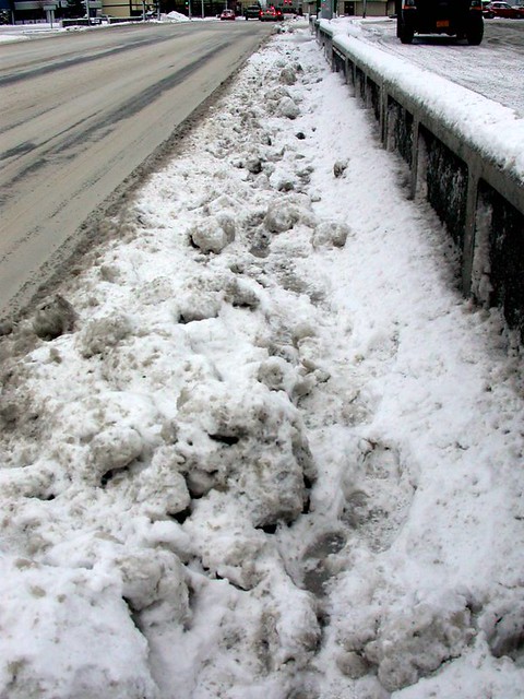 The unfriendly terrain of a wintertime Anchorage sidewalk