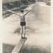 Man stands at the end of a diving board