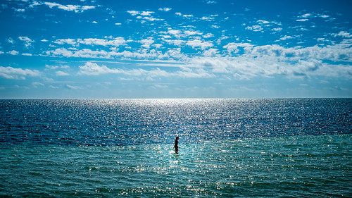 A girl walking on water - Bahia Honda, Florida - Color street photography