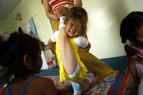 Khulan 6 winces as her leg is stretched behind her neck in a contortion 