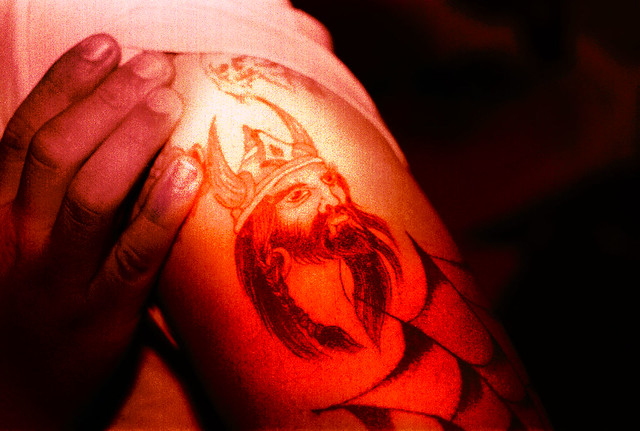 A tattoo of a Viking warrior influenced by Norse mythology