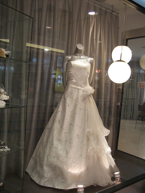 White wedding gown with frills at one side at a shop somewhere near Billy 