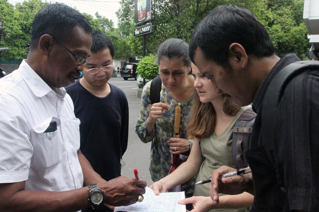 Indonesian local government official helping M.R.P. students, associate professor Victoria Beard, and Fuad Jamil (Indonesian NGO collaborator) from Yayasan Kota Kita map a case study of informal urban settlement in Surakarta, Indonesia. 