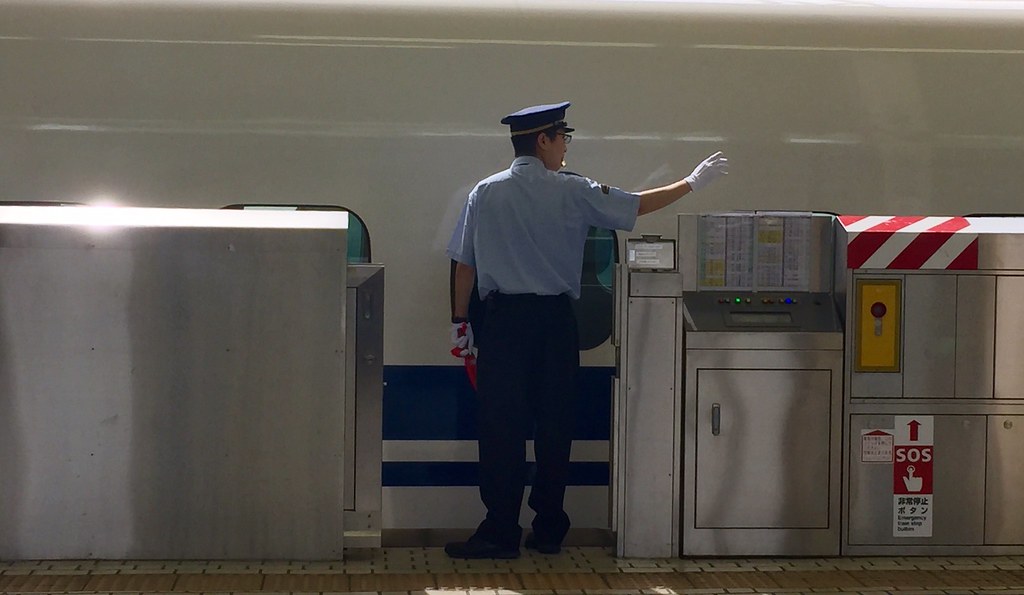 The conductor checks the boarding of people