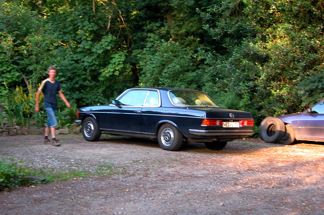 MercedesBenz W123 coupe with blurry boy