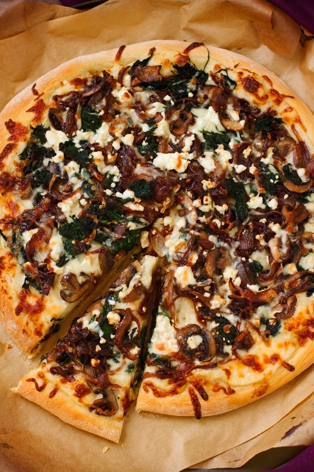 Caramelized Onion Feta Spinach Pizza with creamy white sauce! This pizza tastes like you ordered it at a fancy restaurant But it's simple to make at home! #pizza #caramelizedonions #spinachpizza #greekpizza | Littlespicejar.com @Littlespicejar