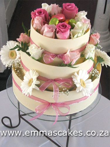 3 Tier wedding cake with flowers White chocolate bands around each tier