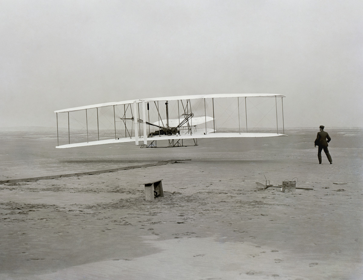 The Wright Flyer airborne during the first powered flight at Kitty Hawk, North Carolina