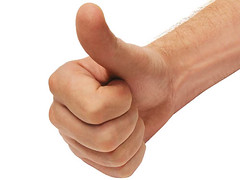photo of a hand with thumb up against a white background