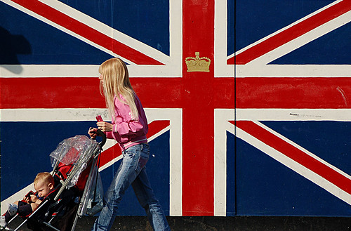 British flag (Union Jack), young girl and a kid in a pram