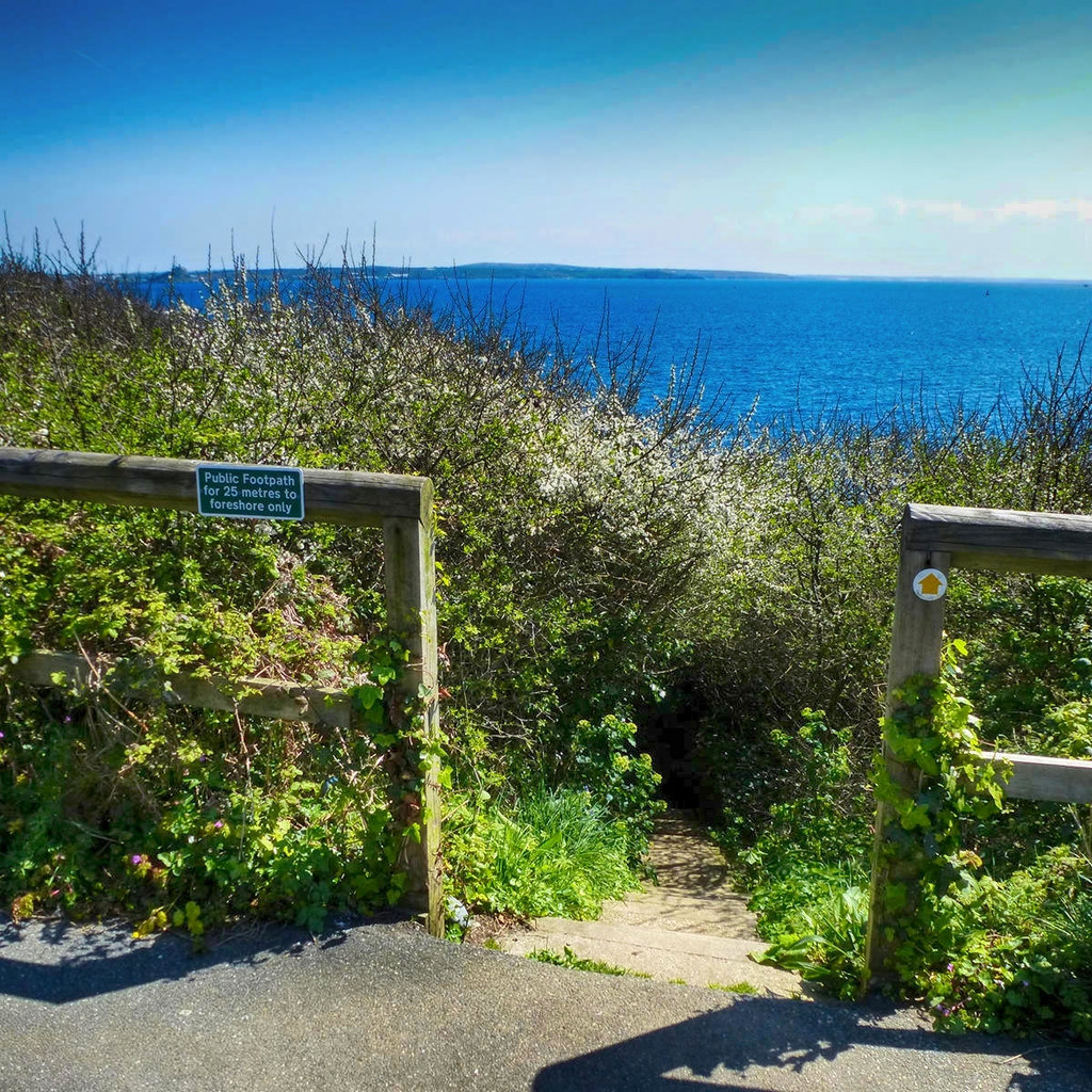 A public footpath down some steps to a Cornish beach. Credit Jane White