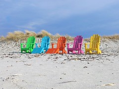 Coulourful chairs at the beach