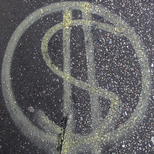 Spray painted dollar sign on street