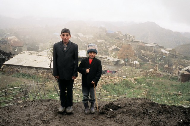 Children near dilapidated village