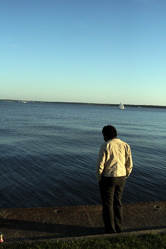 blue sky woman green grass sailboat standing concrete view sister peaceful resevoir jacksonms