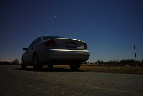 road longexposure sky ford car night sedan stars landscape telephone country rear pole powerlines taurus threequarter