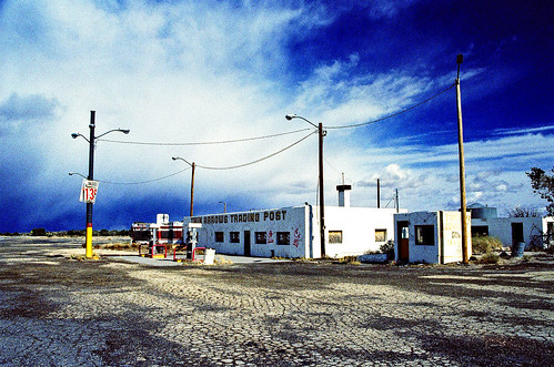 eyetwist 2007 ishootfilm nikon n90s nikkor 28105mmf3545d xpro crossprocess crossprocessed ishootfuji rdp fujichrome analog analogue emulsion film contrast saturated route66 arizona motherroad mother road roadtrip desert southwest arid dry usa us66 route 66 america americana photoimpact noritsukoki abandoned derelict empty loney truckstop truck stop bypassed interstate twinarrows twin arrows clouds sunset trading post gas closed service station gasoline twinarrowstradingpost pumps i40 40 american west decay landmark