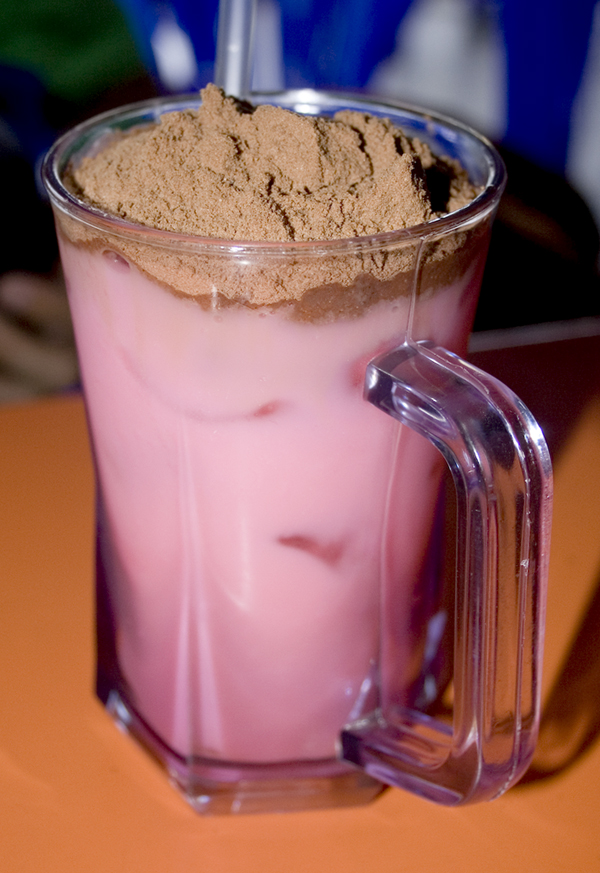Bandung - a drink made out of rose syrup and evaporated milk - is topped with milo powder for this decidedly decadent local treat. 