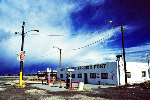 eyetwist 2007 ishootfilm nikon n90s nikkor 28105mmf3545d xpro crossprocess crossprocessed ishootfuji rdp fujichrome analog analogue emulsion film contrast saturated route66 arizona motherroad mother road roadtrip desert southwest arid dry usa us66 route 66 america americana photoimpact noritsukoki abandoned derelict empty lonely truckstop truck stop bypassed interstate twinarrows twin arrows clouds sunset trading post gas closed service station gasoline twinarrowstradingpost pumps i40 40 american west decay landmark