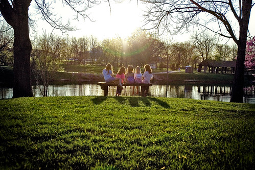 park friends sunset sky sun lake reflection grass kids bench children rays