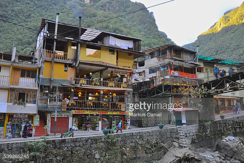 houses people mountains tourism peru southamerica grass rock horizontal inca wall buildings river outdoors town day stones tourist andes shops destination machupicchu stores aguascalientes gettyimages urubambavalley