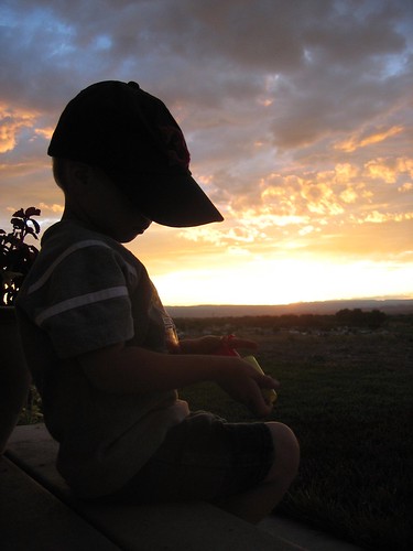 silhouette hat sunset kid brother porch child children boy clouds thinking cute