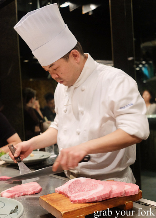 Teppanyaki chef with Kobe wagyu beef sirloin at Wakkoqu, Kobe, Japan