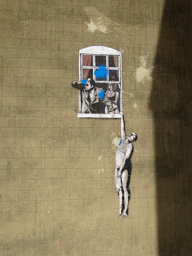 Banksy - naked man hanging from window