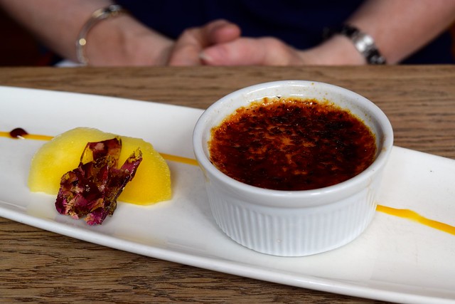 Rose & vanilla crème brulee served with fresh mango, dehydrated rose petals at The Ambrette, Canterbury