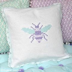 Cross stitch bee cushion and pom pom bench cushion