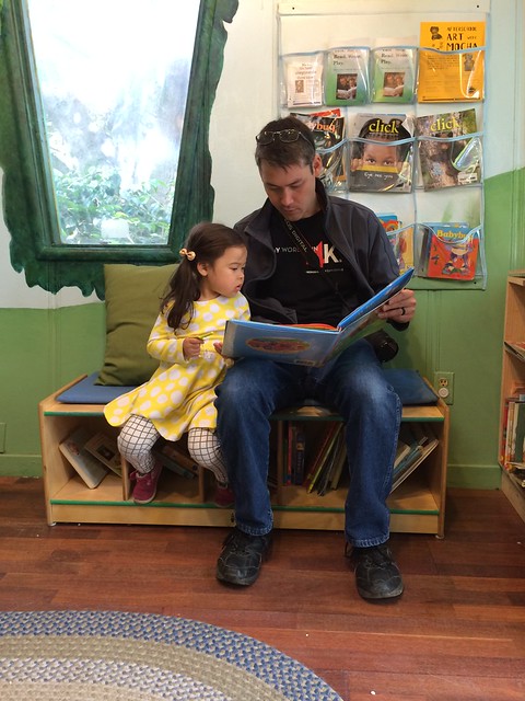 Daddy reading to Mio in the reading room