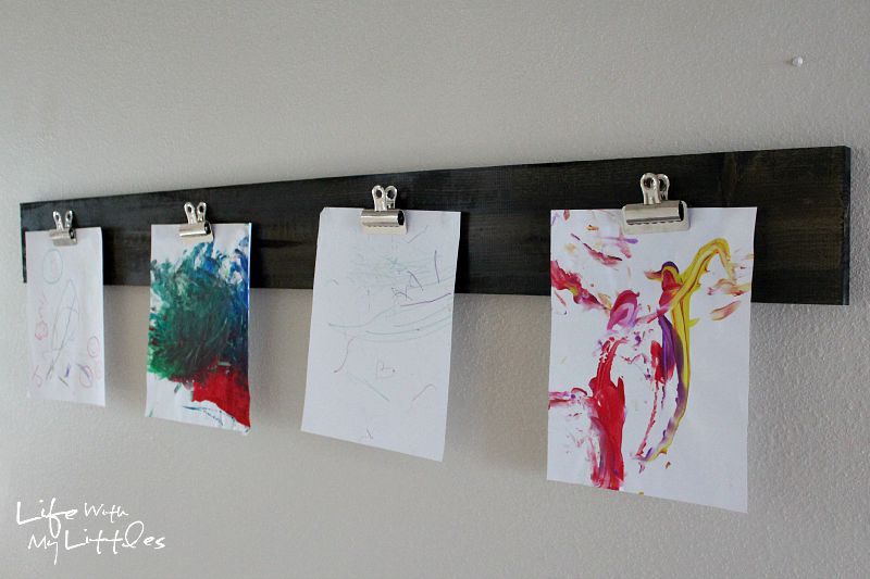 This cheap and easy way to display your child's artwork is made with a wood board and clips! It's super simple, but looks expensive!
