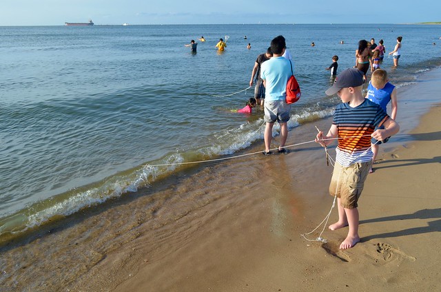 Rangers are on the beach to help teach  visitors how to use crab lines. First Landing State Park, Virginia offers crabbing programs all summer long 