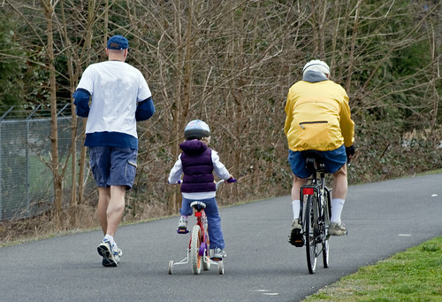 Bicycle & Jogger with child ride along the bike path