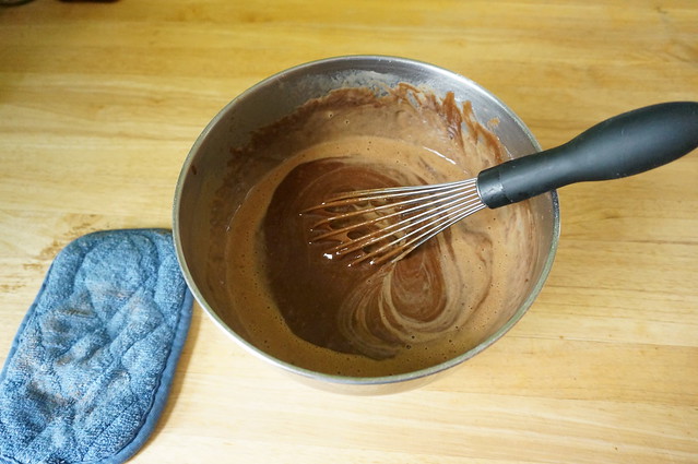 Halfway through whisking in the buttermilk mixture, delicate spirals of light brown show against the dark chocolate