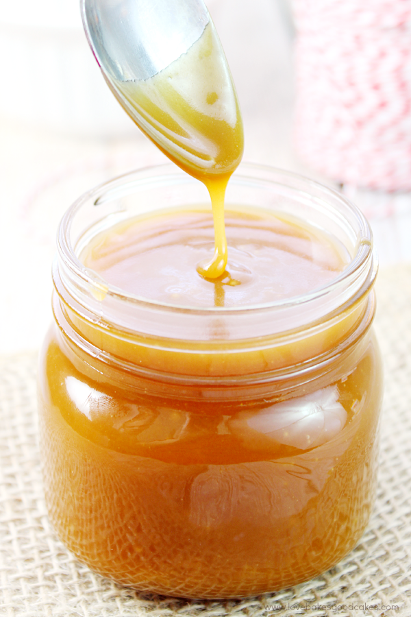 Salted Caramel in a glass jar with a spoon.