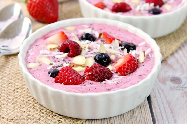 Mixed Berry Smoothie Bowls close up with fresh strawberries.