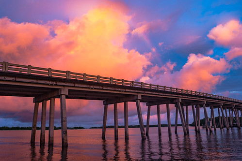 road bridge sunset red sky orange color reflection nature water horizontal architecture clouds sunrise underpass landscape outdoors bay pier us rainbow twilight gulf unitedstates florida surreal overpass wideangle nobody structure northamerica inlet waterway goldenhour firey bonitasprings loverskey