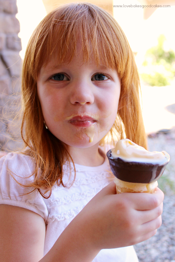 Girl eating an ice cream cone.