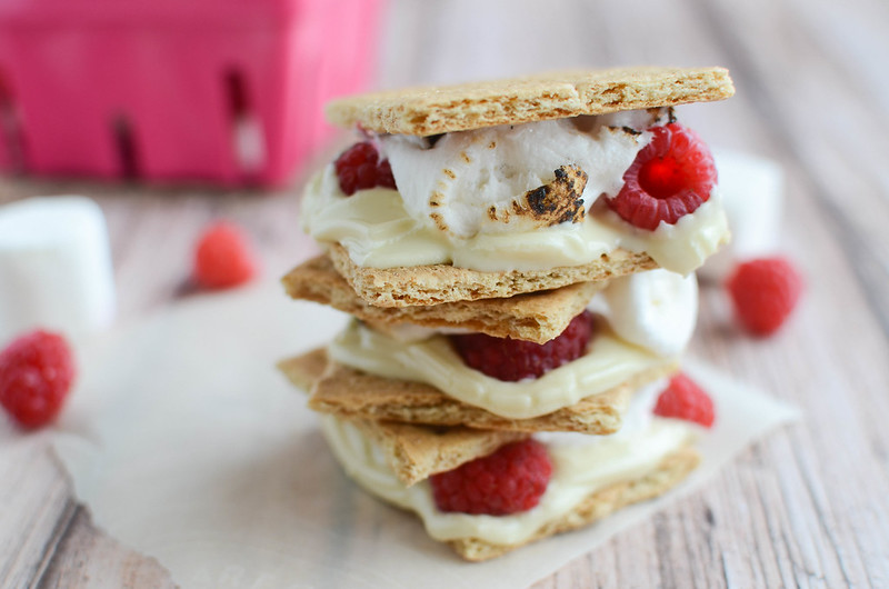 Raspberry White Chocolate S'mores - a new twist on the classic! Fresh raspberry and white chocolate with toasted marshmallows and graham crackers!